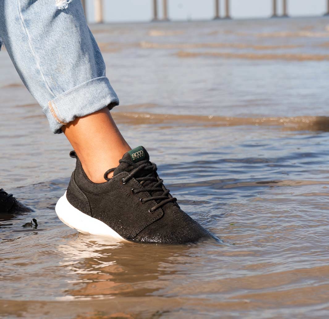 Black Vegan Sneakers being dipped in water